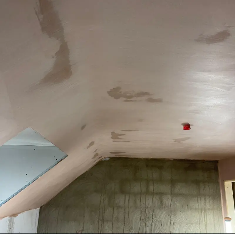 Sloped ceiling skimmed to a smooth finish in a loft room