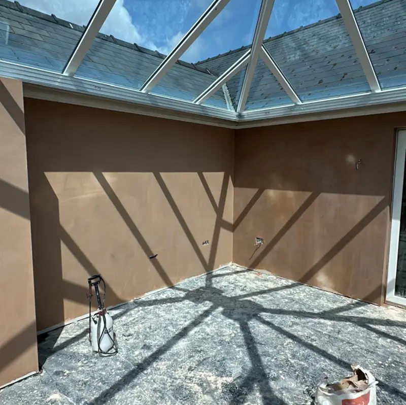 Orangery walls plastered beneath a glazed lantern roof
