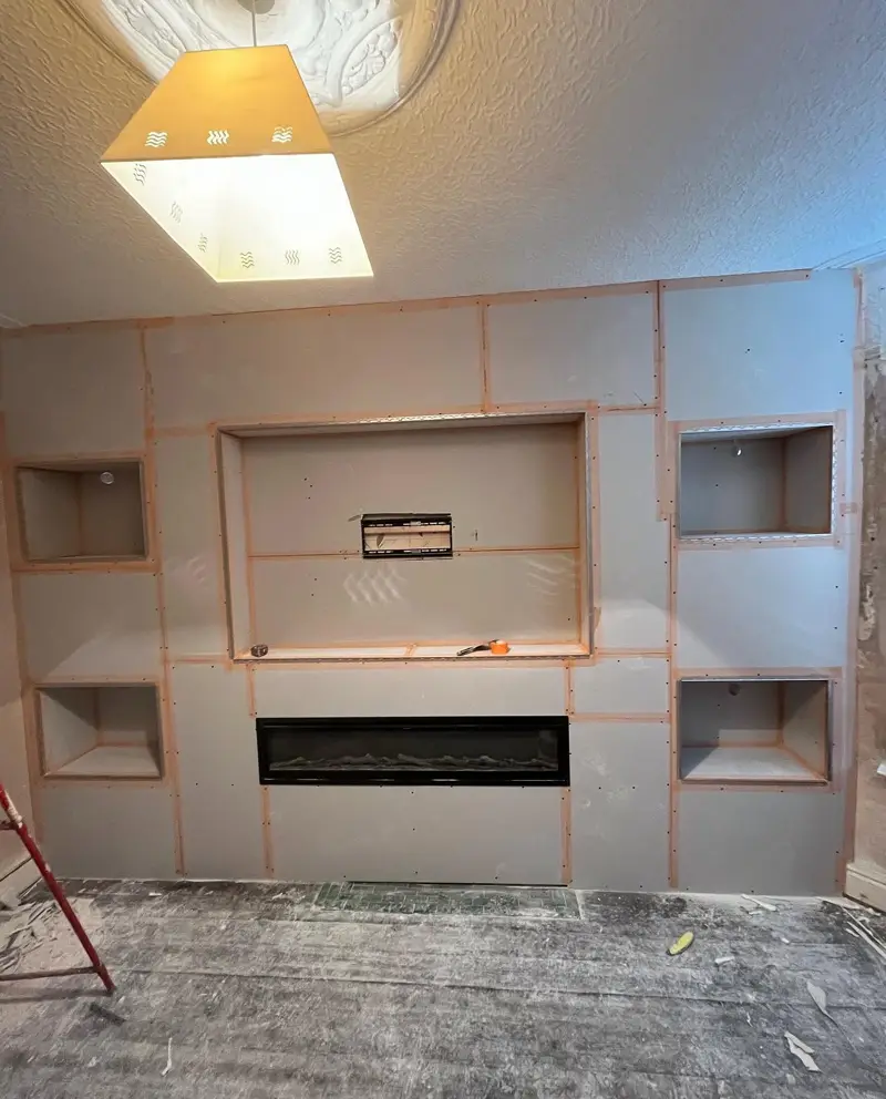Media wall boarded with plasterboard, with alcoves and fire recess