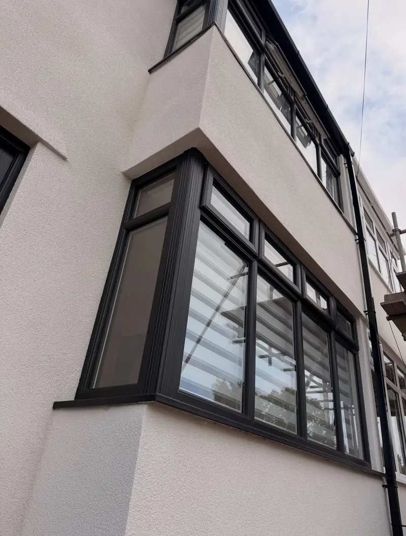 Bay-fronted house finished in white render