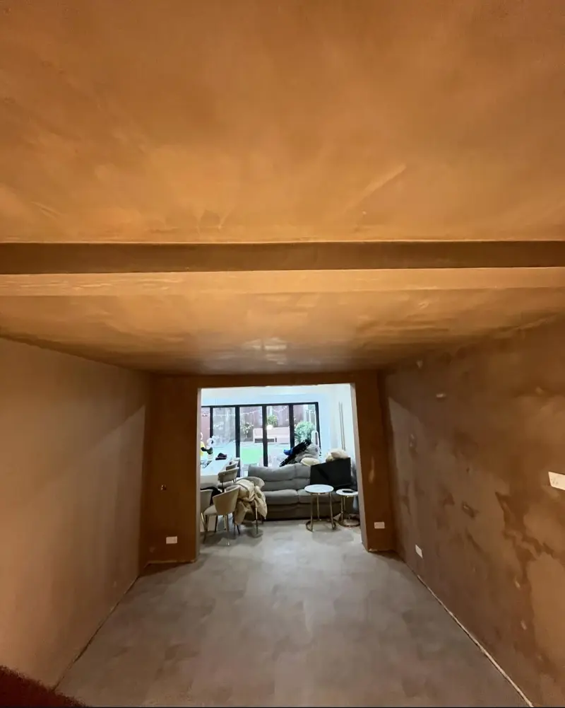 Long through-lounge ceiling and walls freshly plastered