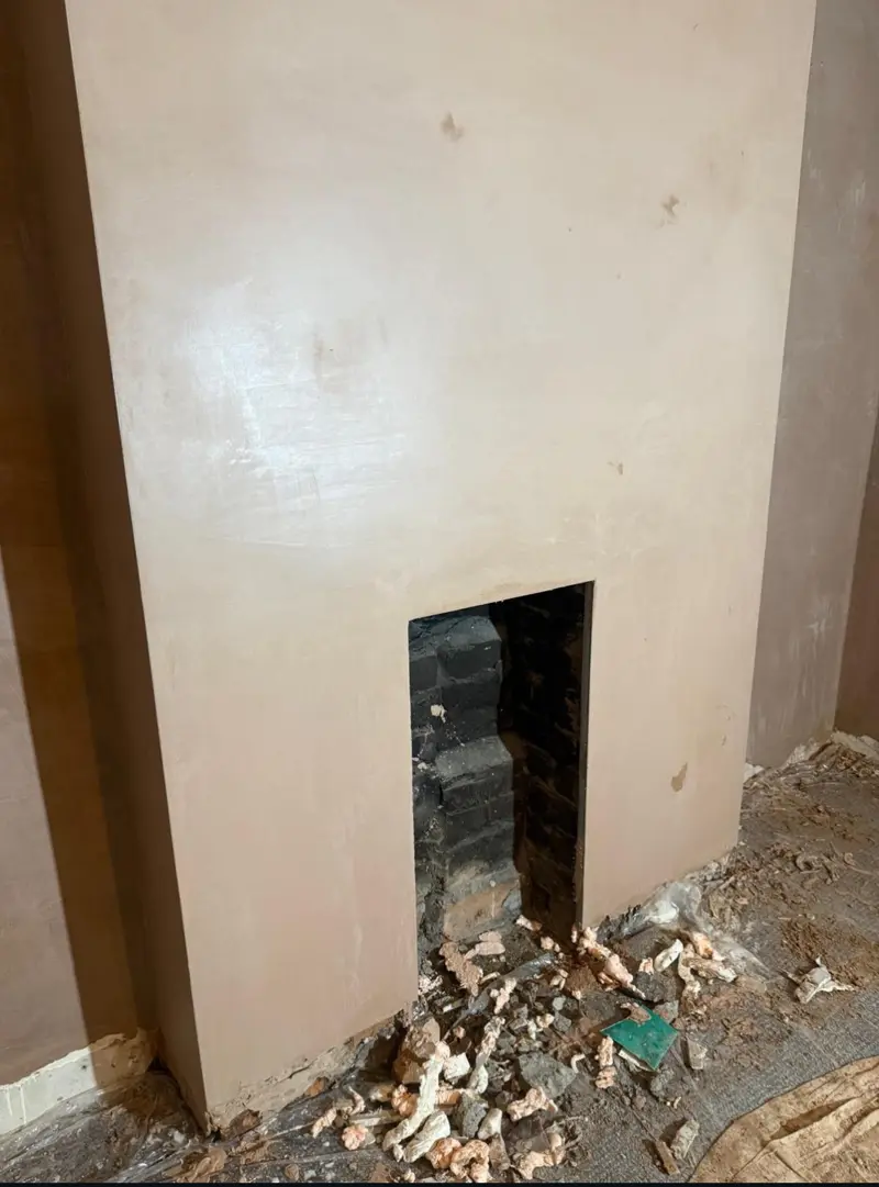 Chimney breast replastered with a clean finish around the opening