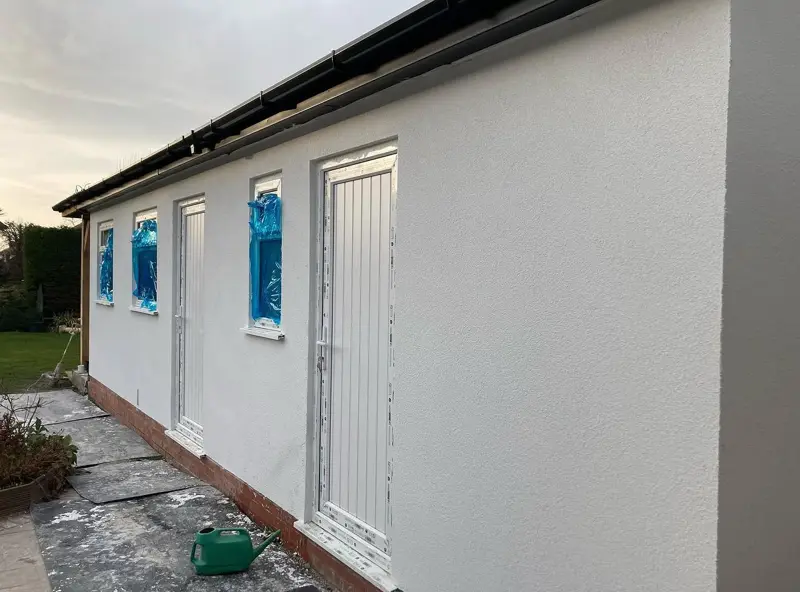 Side wall of a property finished in fresh render