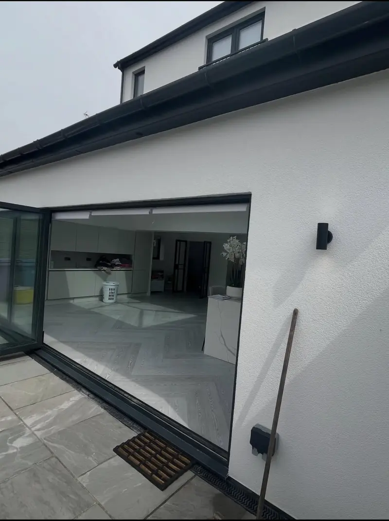 Modern house finished in white render with dark cladding