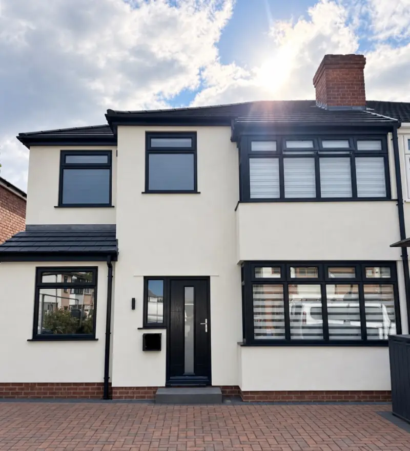Bay-fronted house finished in white render