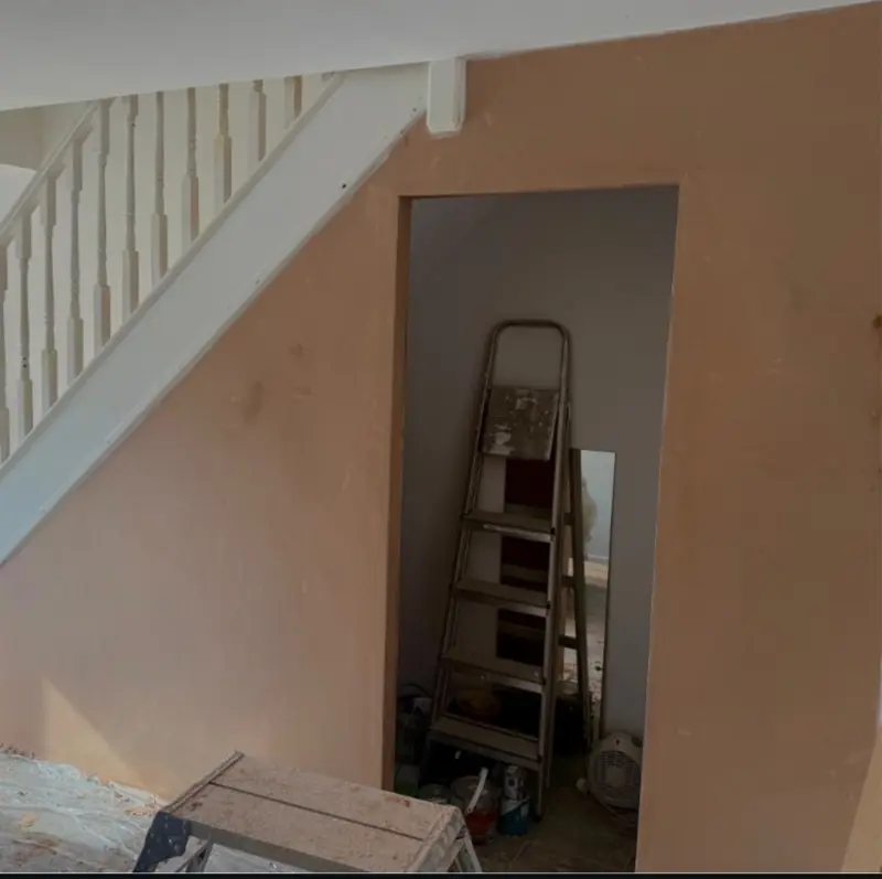 Hallway and under-stairs walls freshly plastered