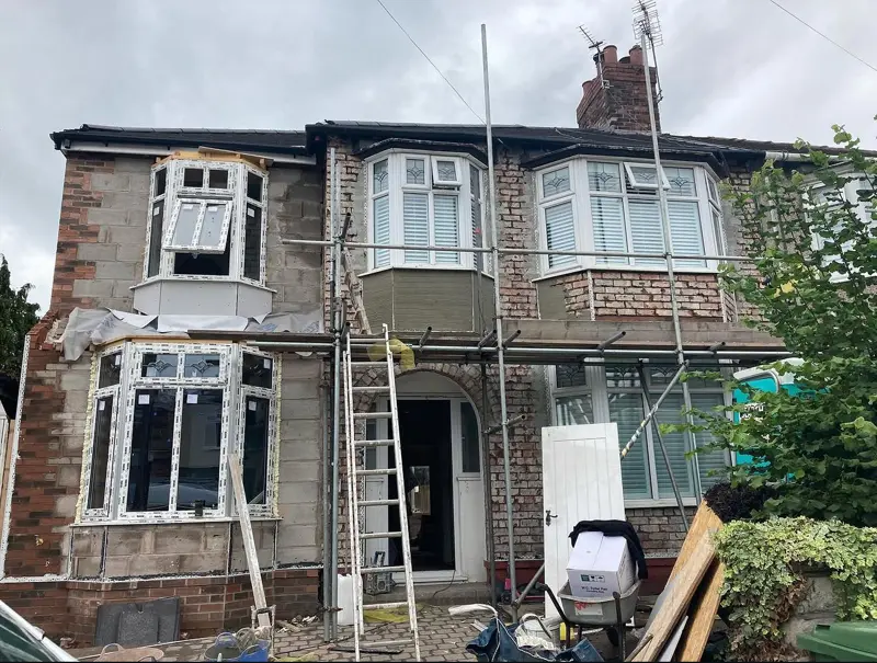 Semi-detached house with scaffold up before rendering
