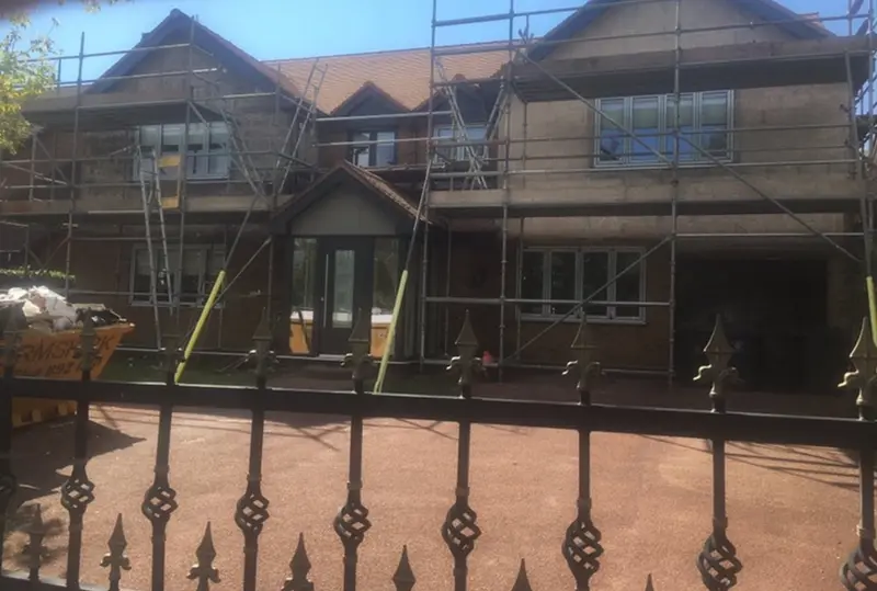 Detached house under scaffold before rendering