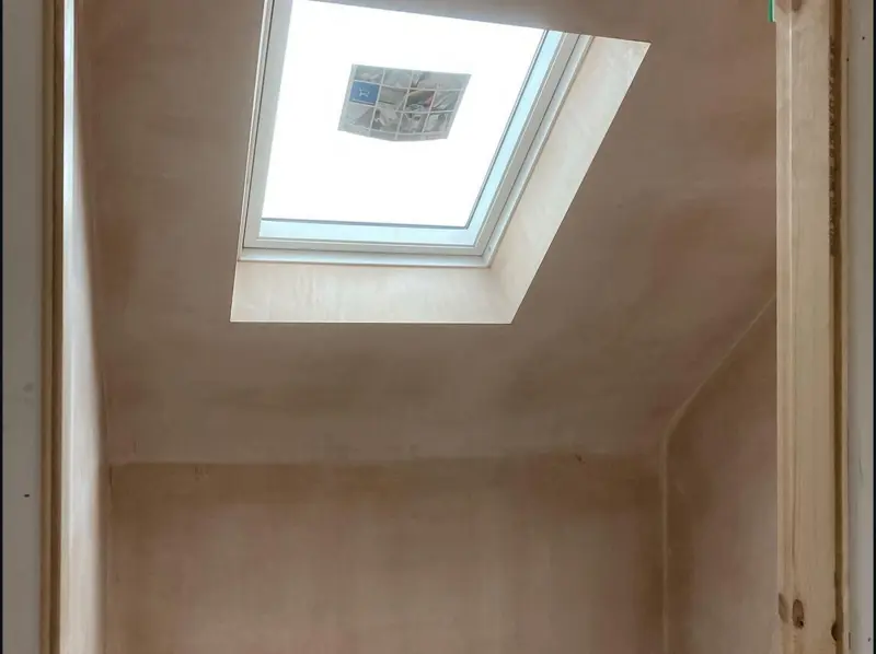 Extension ceiling plastered neatly around roof windows