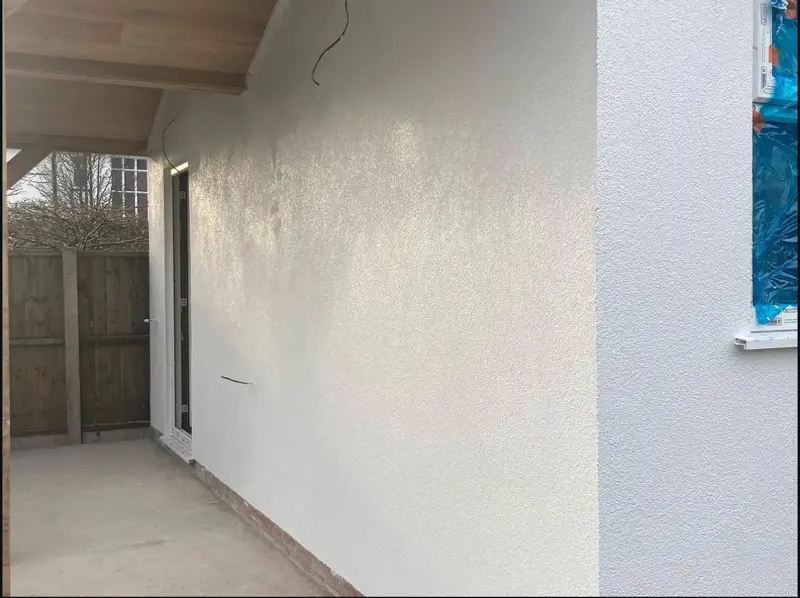 Side wall of a property finished in fresh render