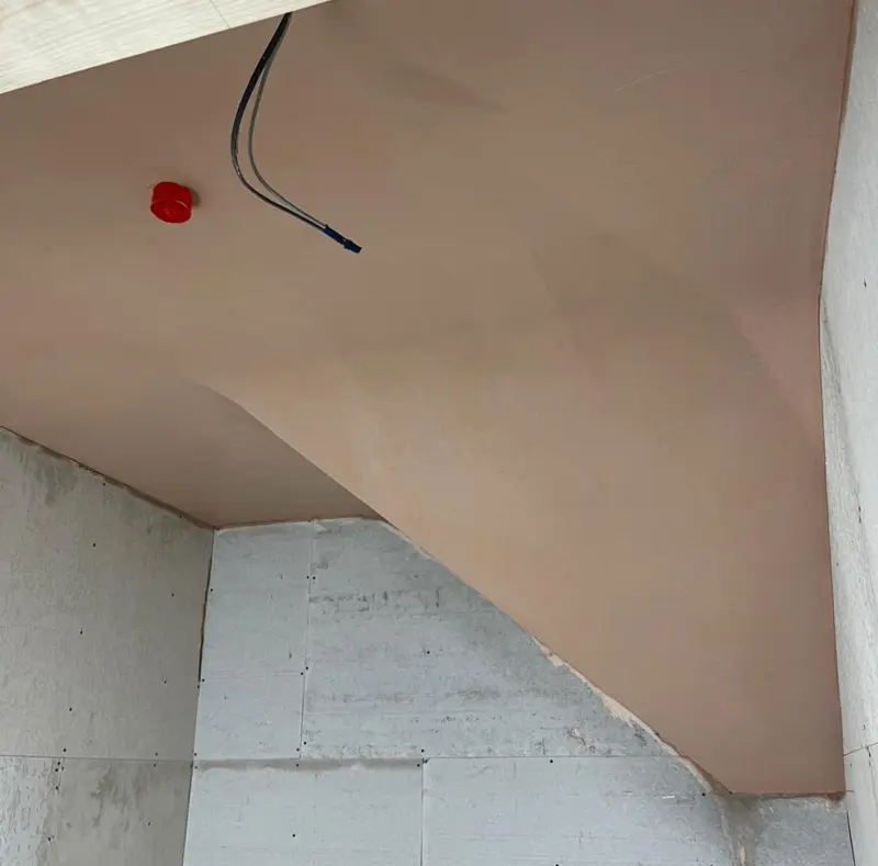 Sloped ceiling skimmed to a smooth finish in a loft room
