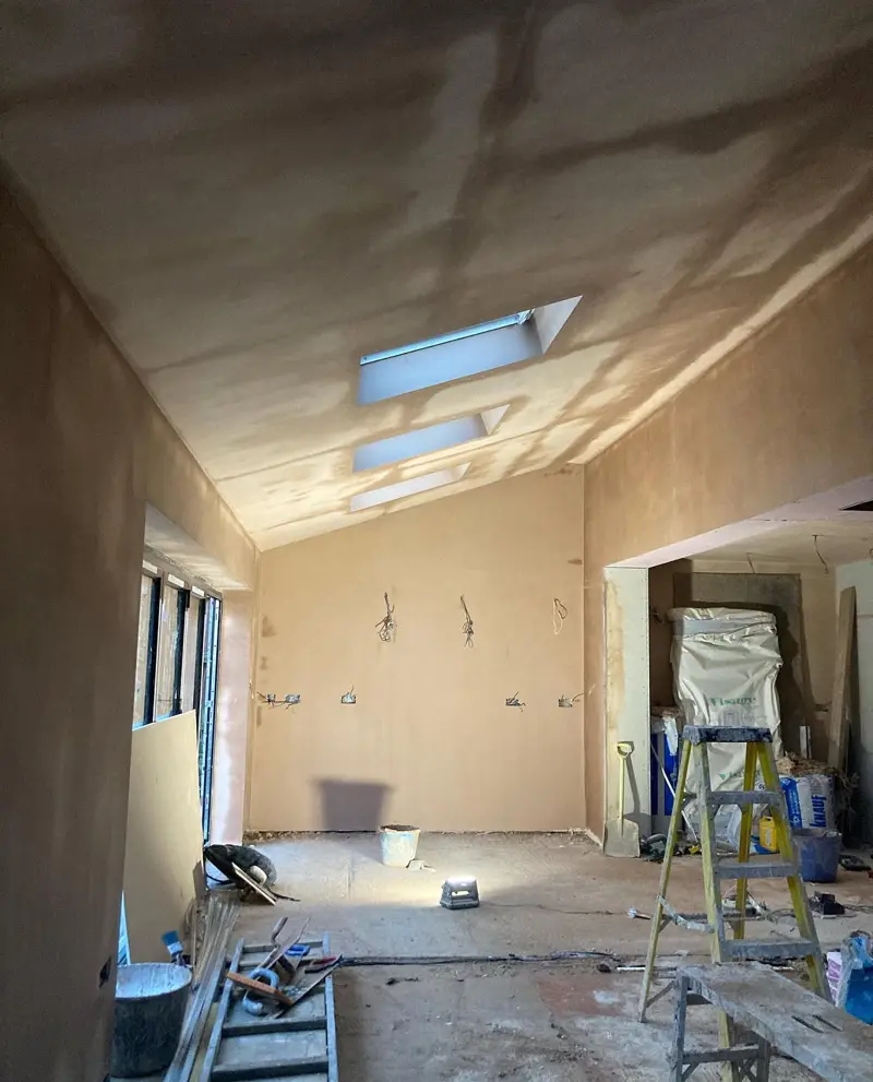 Extension ceiling plastered neatly around roof windows