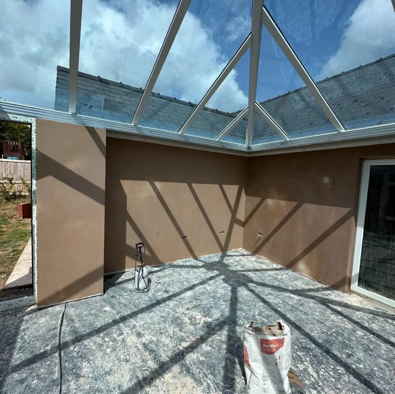 Orangery walls plastered beneath a glazed lantern roof