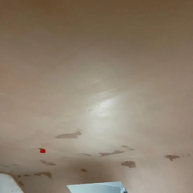 Sloped ceiling skimmed to a smooth finish in a loft room
