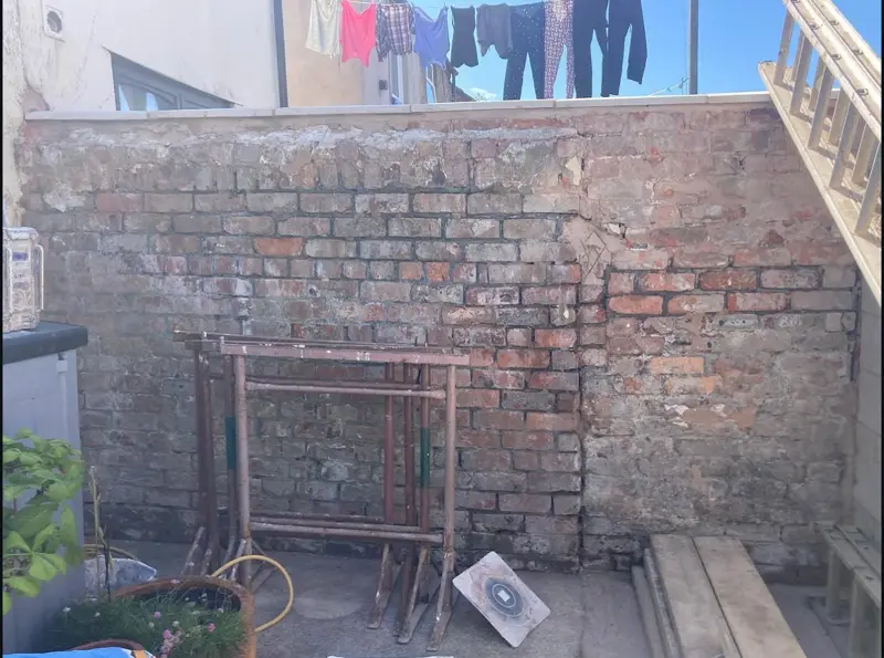 Brick garden wall before rendering