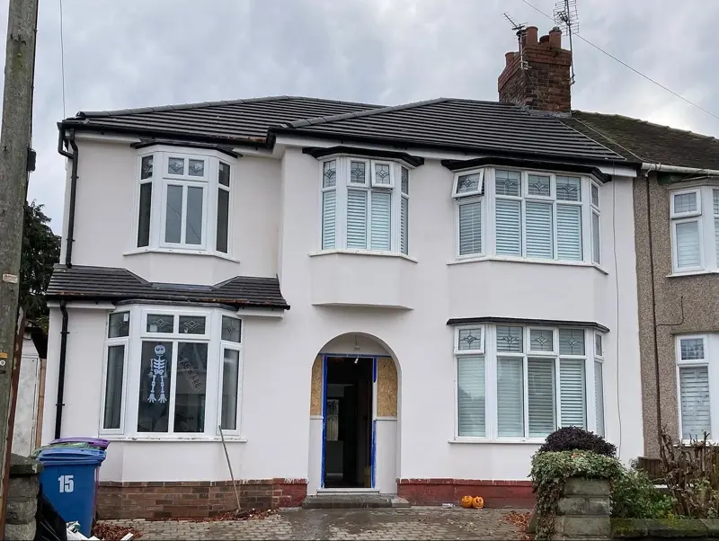 Semi-detached house after a full white render