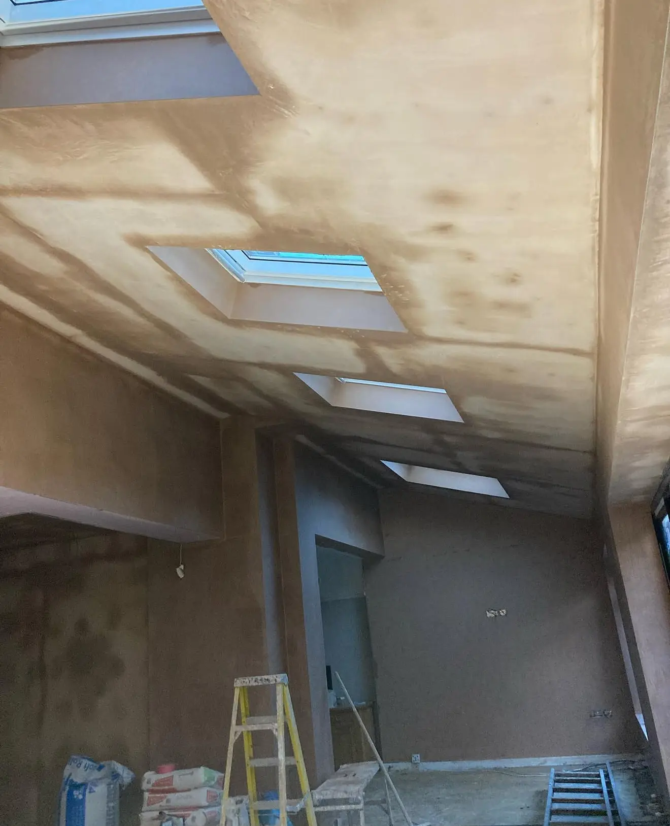 Extension ceiling plastered neatly around roof windows