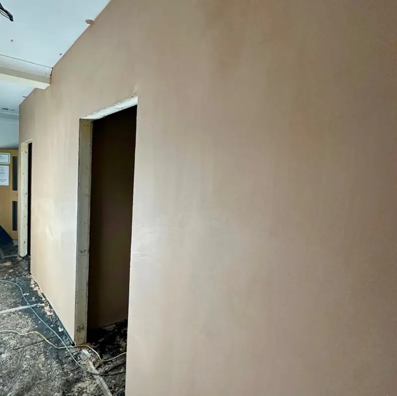 Freshly skimmed wall with a smooth, even plaster finish ready for decorating